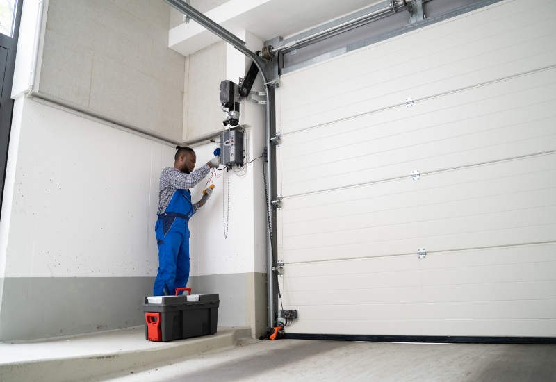 Campbell Overhead Door Worker Fixing A Garage Door In San Jose, CA